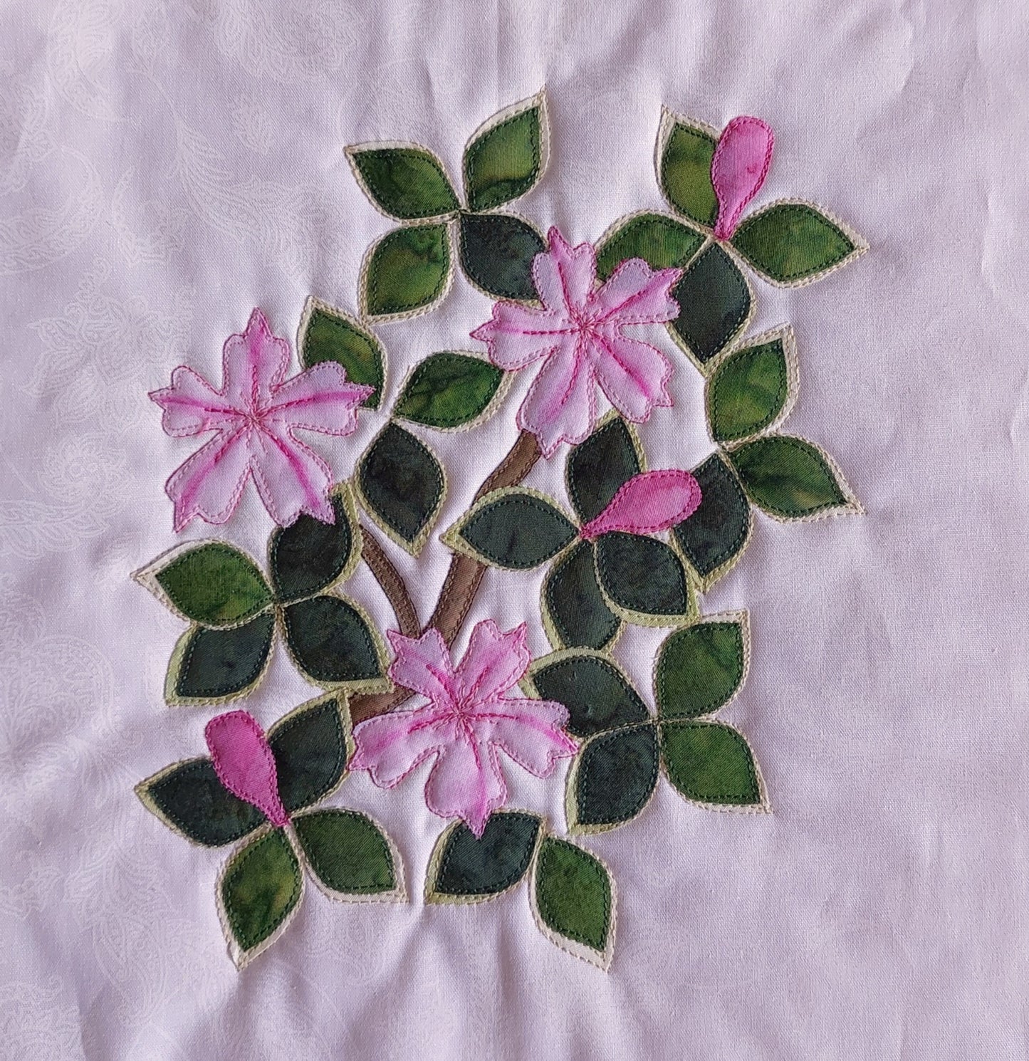 Snowrose flower block with two tone leaves, painted and stitched flowers plus buds using Hoffman Fabric water colors