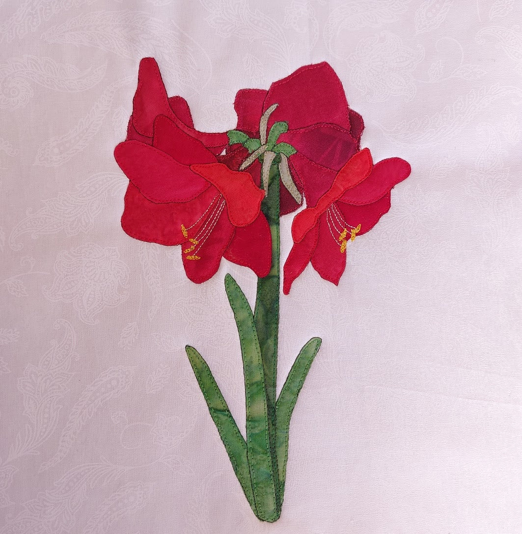 Amaryllis Belladonna flower applique block made with red and green fabrics
