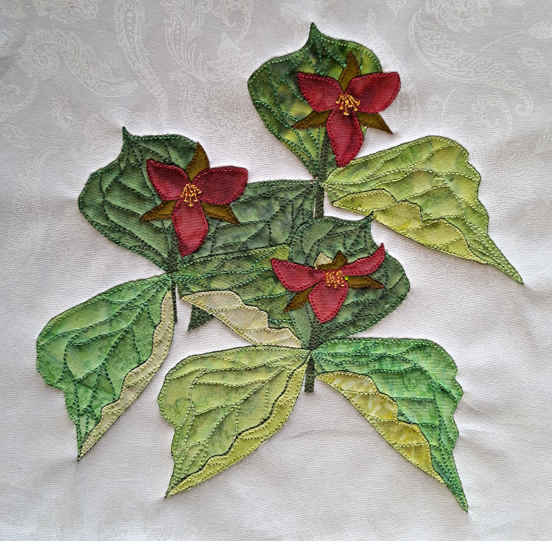 Trillium flower block pattern includes instructions for machine applique, hand applique, free-form embroidery by hand or machine, and quilting