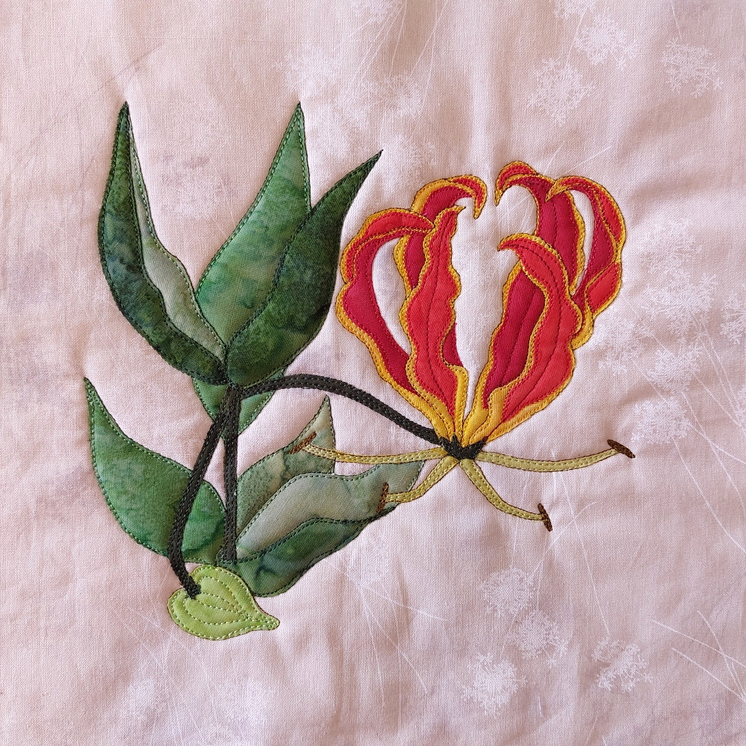 Flame Lily quilt block gets its name from its fire petals and makes up the 60th flower in the BOW flower block series