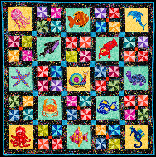 baby quilt pattern with ocean theme including dolphin, fish and octopus and pinwheel patchwork blocks designed by Jennifer Houlden