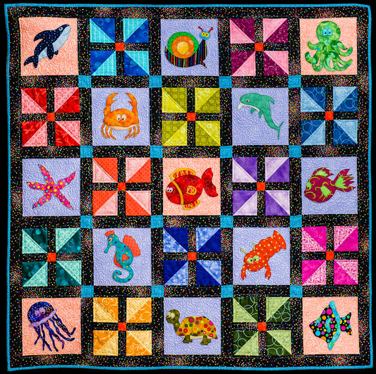 baby quilt pattern with ocean theme including snail, jellyfish and seahorse and simple patchwork blocks designed by Jennifer Houlden