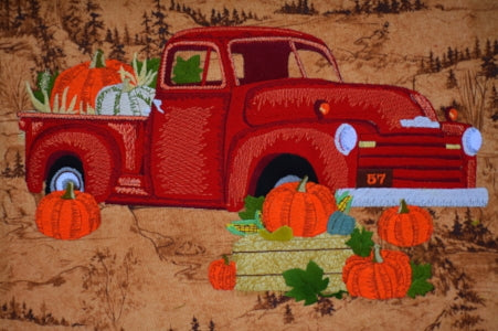 Embroidery design of a red chevy truck and pumplins