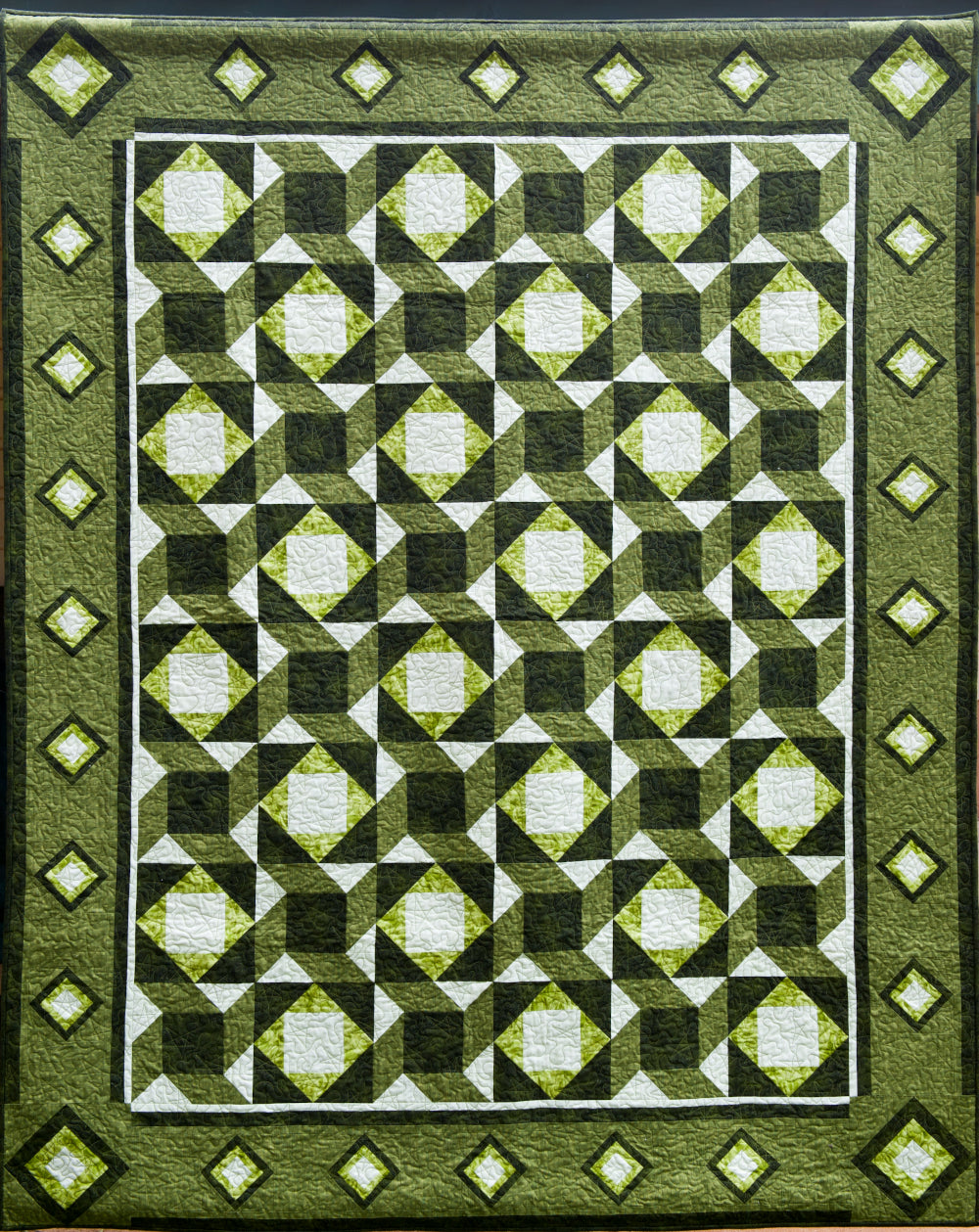 a green patchwork quilt pattern representing woven stars by Jennifer Houlden