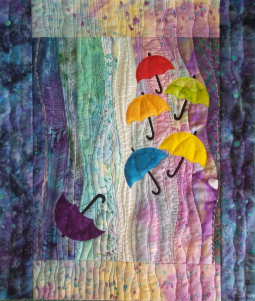 art quilt pattern with umbrellas and decorative stitching. Includes beading and cording using free-motion quilting