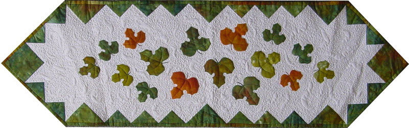 Fall leaves along a table runner with pieced border - quilt pattern
