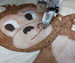 stitching on the monkey applique block