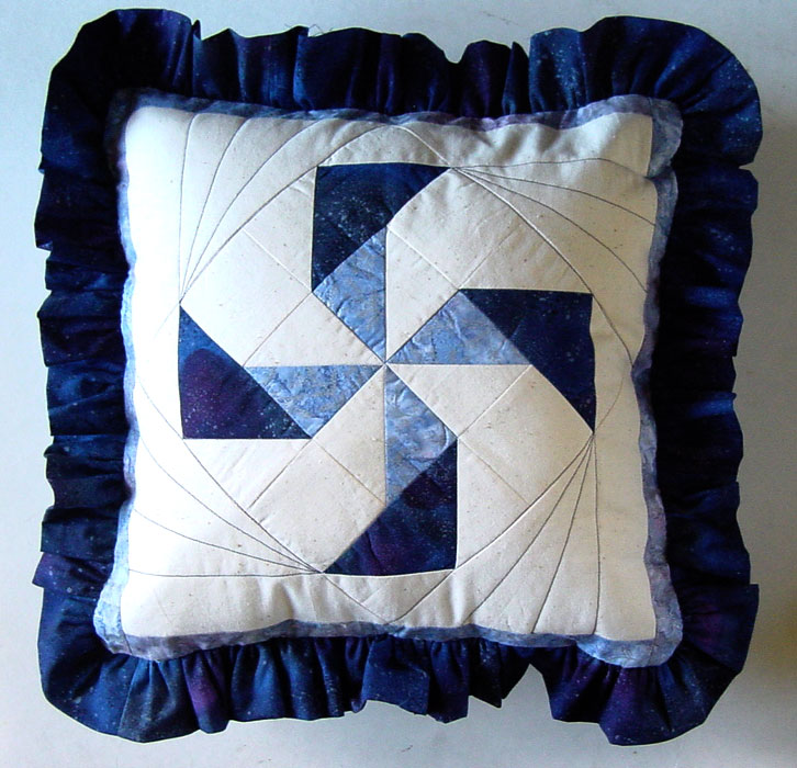pinwheel patchwork pattern for a cushion that is ideal for beginner patchworkers or quilters