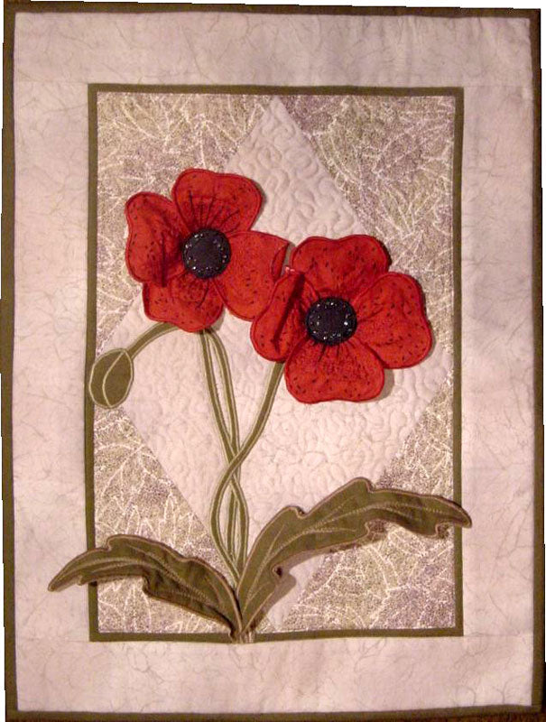three dimenstional applique poppies on a quilt. 