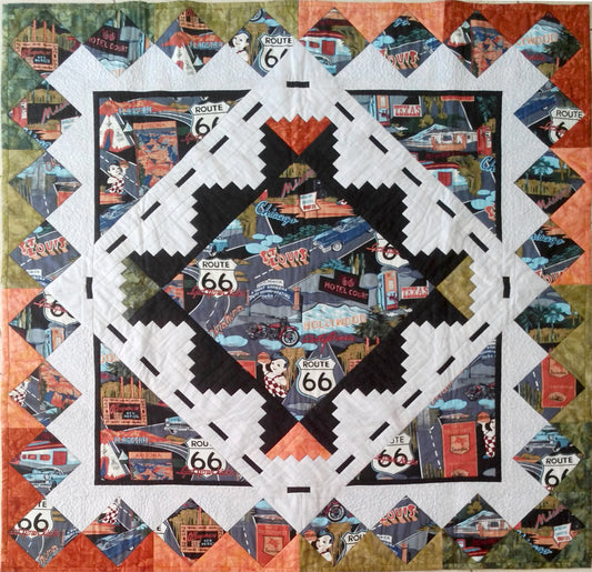 scenic quilt pattern with log cabin blocks and square in a square block using a colorful print fabric