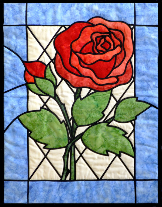 stained glass applique rose with bud quilt pattern that includes blue border - designed by Ruth Blanchet
