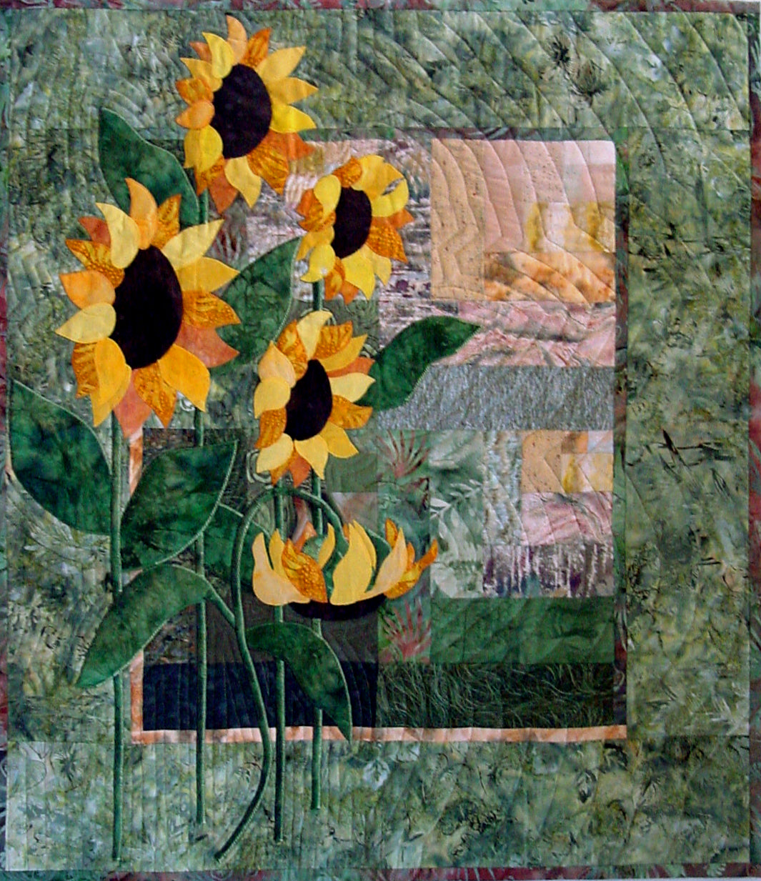 a classic sunflower quilt pattern by Ruth Blanchet created with applique sunflowers and an offset log cabin block background