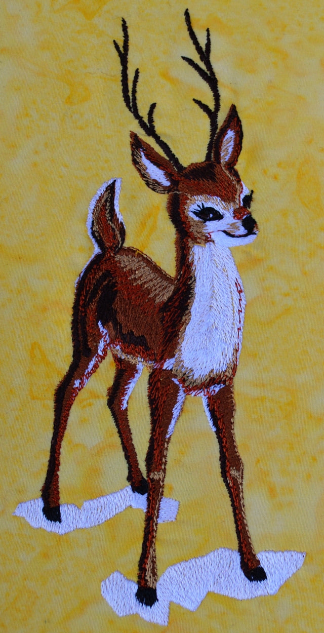 Embroidery design of a young buck in snow
