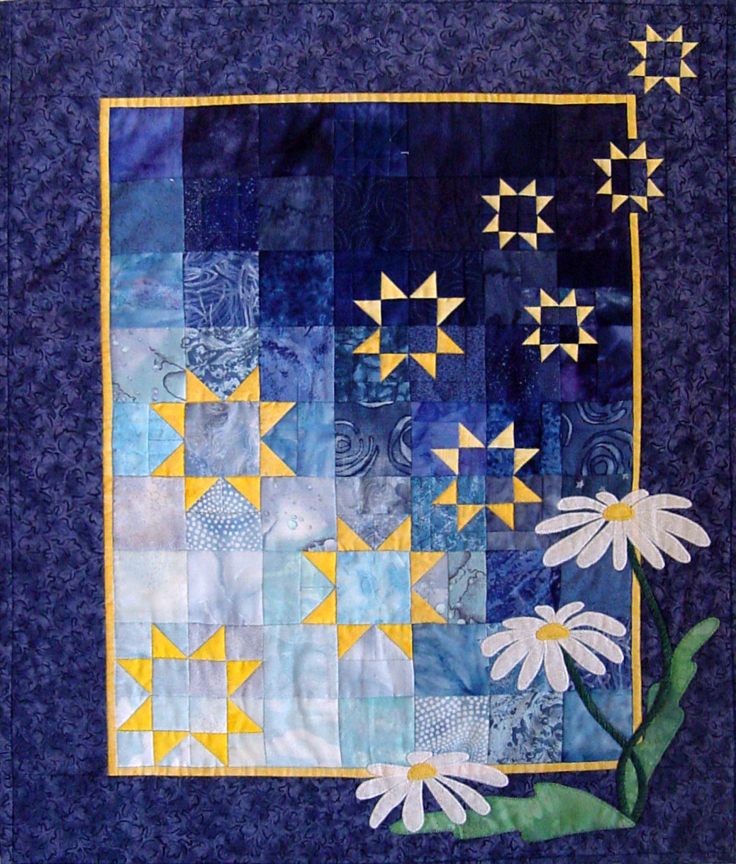 patchwork background of star shaped with appliqued daisies - this quilt pattern is designed by Ruth Blanchet