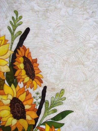 A close up of the quilting and applique detail for sunflower bouquet, a quilt pattern designed by Ruth Blanchet